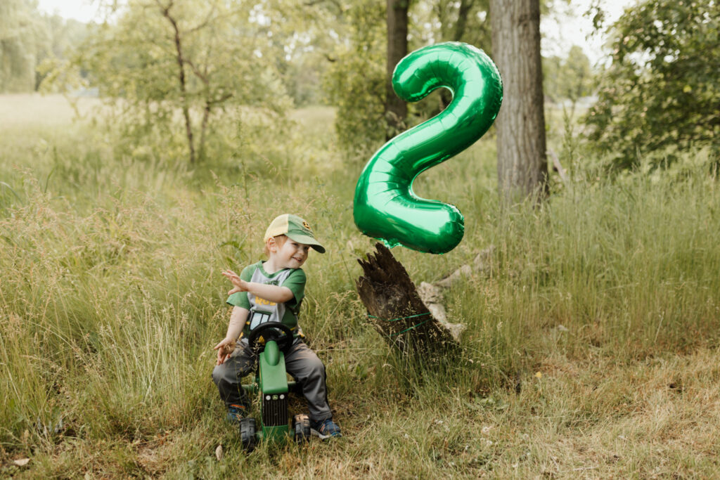 Two year old john deere green themed birthday party documenting a milestone with northern michigan photographer