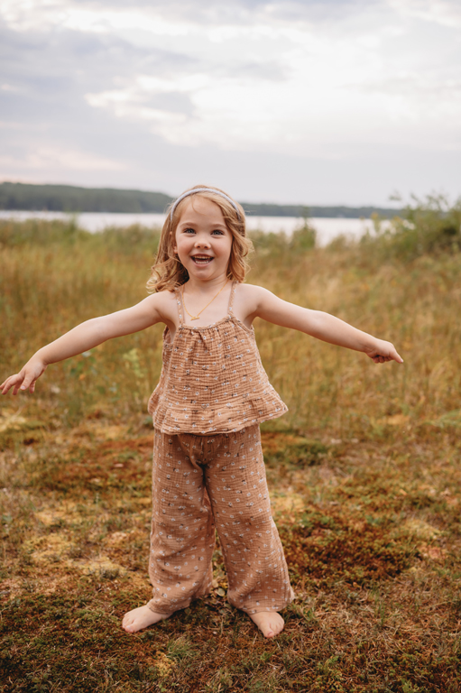 little girl playing in moss