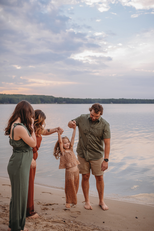 family playing by Otsego Lake, Michigan